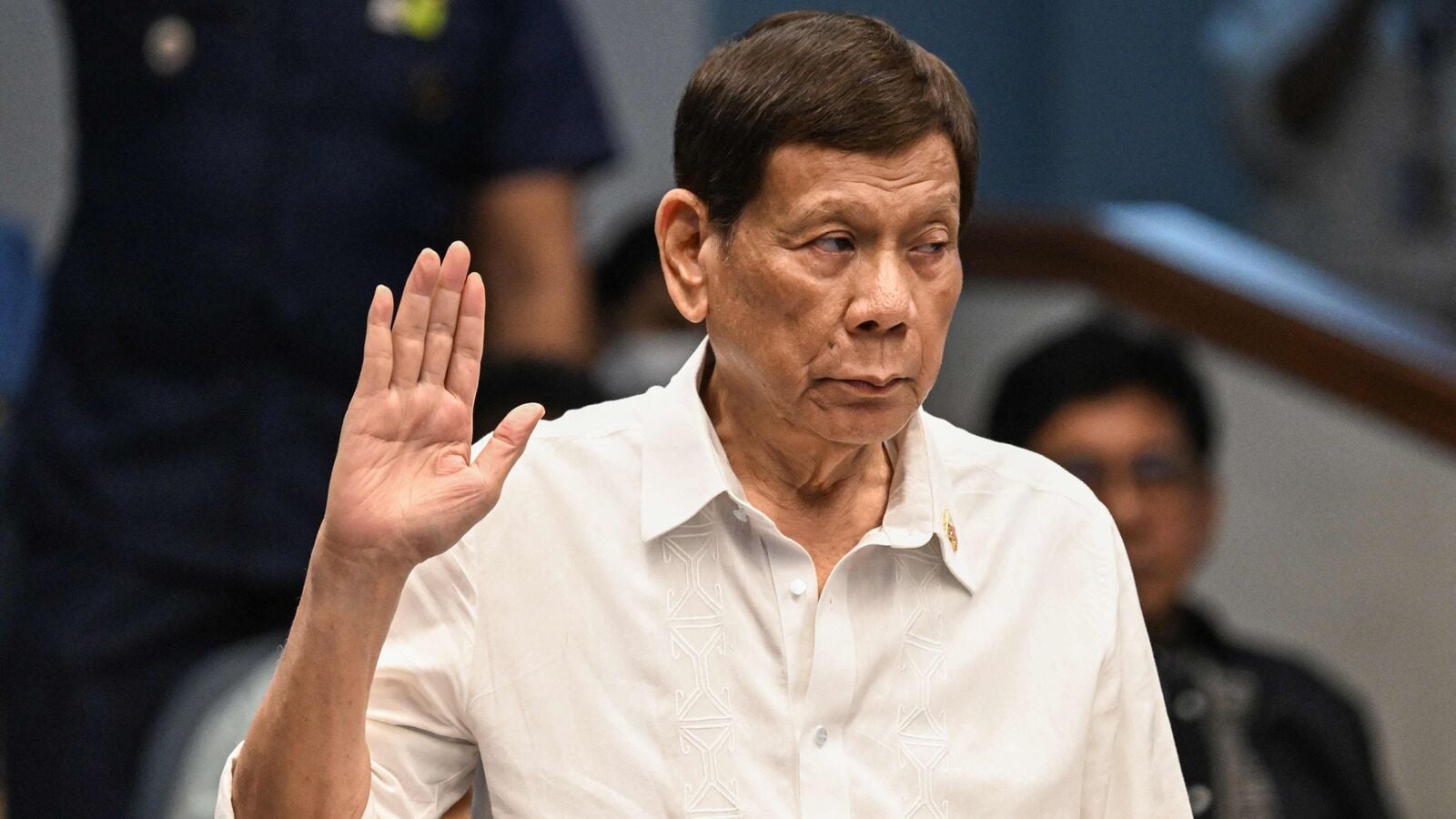 (FILES) Former Philippine president Rodrigo Duterte takes an oath as he attends a senate probe on the drug war during his administration, in Manila on October 28, 2024. Former Philippines president Rodrigo Duterte was arrested on March 11, 2025 after landing at Manila's international airport by police acting on an International Criminal Court warrant over his deadly war on drugs, the presidential palace said. (Photo by JAM STA ROSA / AFP)