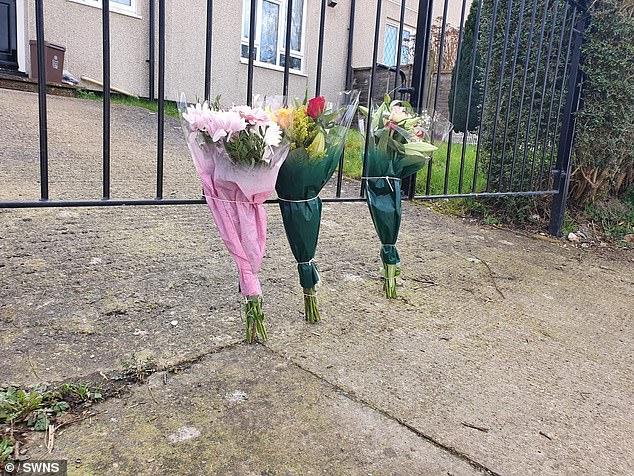 Flowers laid by grieving friends and family pictured outside Morgan's cousin's flat where the attack happened