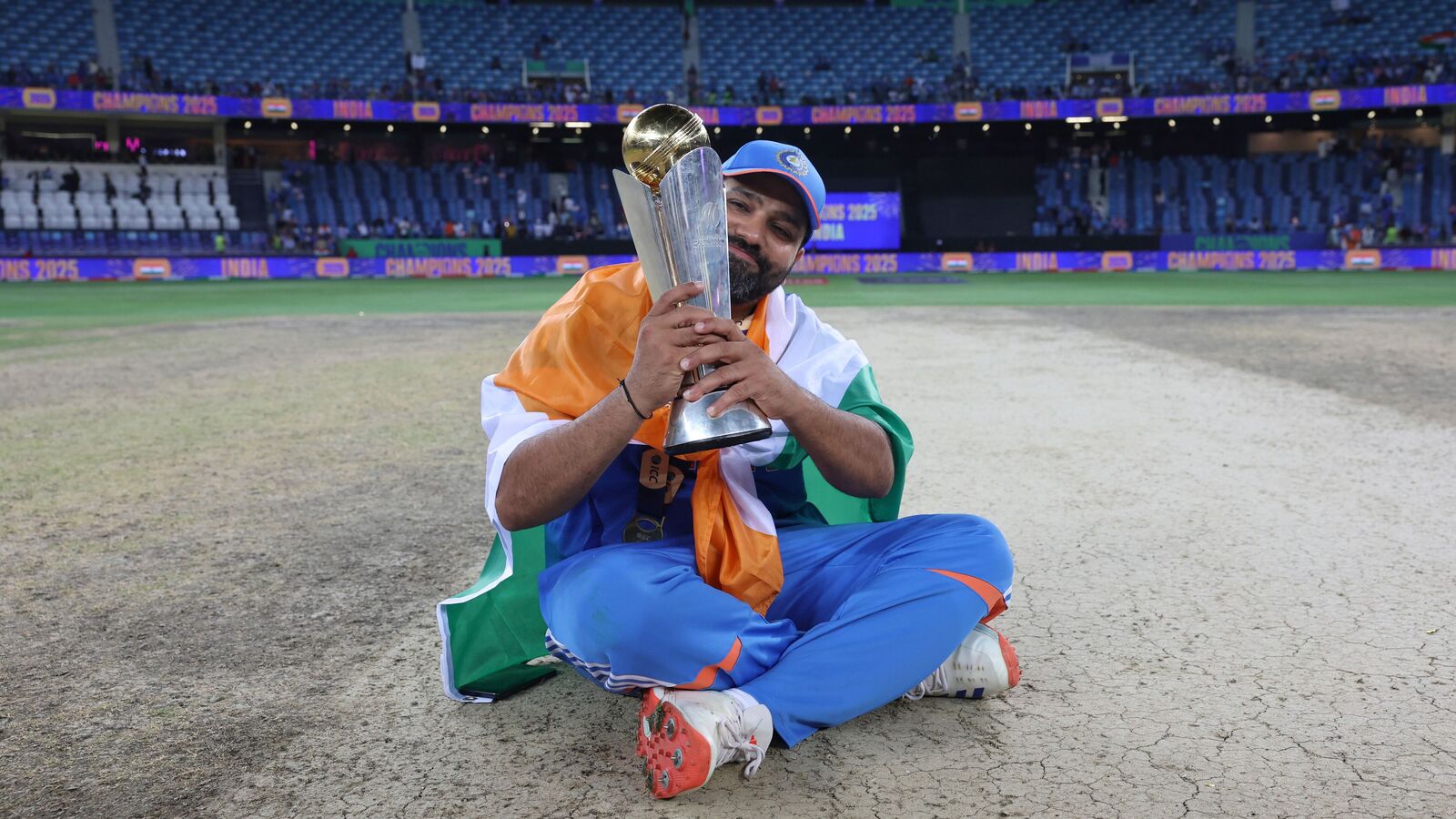 India's captain Rohit Sharma poses with the ICC Champions Trophy 2025 after defeating New Zealand in the final.