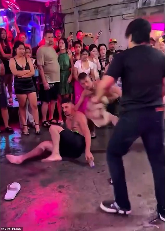 Shocked crowds watched on as the man helplessly took the beating