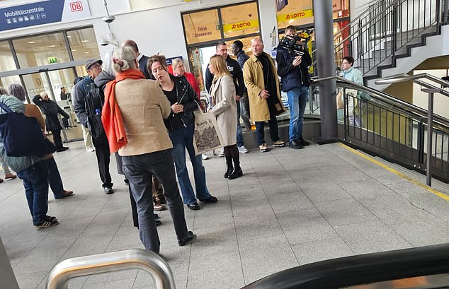 Fallyn Ball (wearing a black leather jacket) is pictured above at Kaiserslautern station scene of the fatal stabbing from last year with members of the court