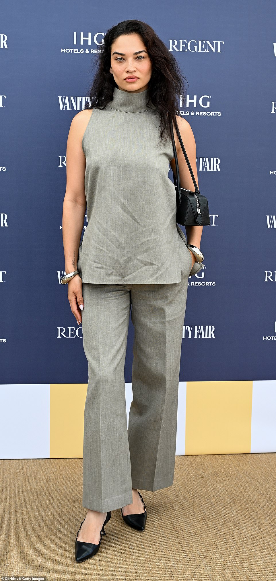 Shanina sported a barely-there make-up look and natural hair and paired her tailored ensemble with black leather stilettos as she attended the Vanity Fair lunch later that day