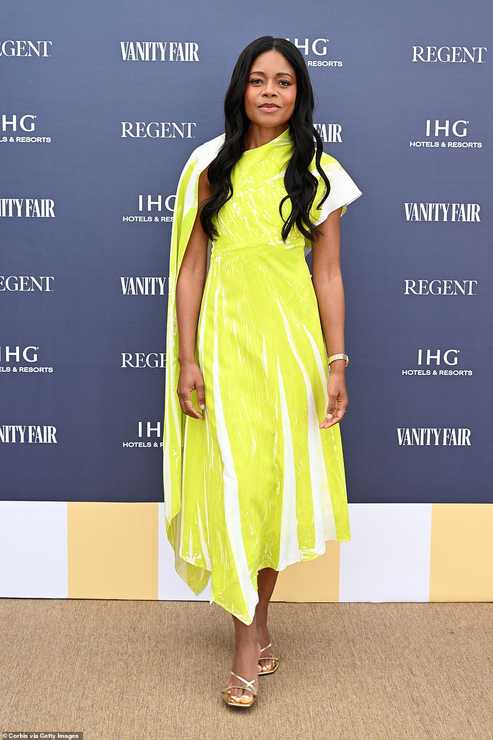Actress Naomie Harris made a colourful appearance as she donned a bright yellow and white striped midi-dress complete with a capped sleeve and drooping cape design