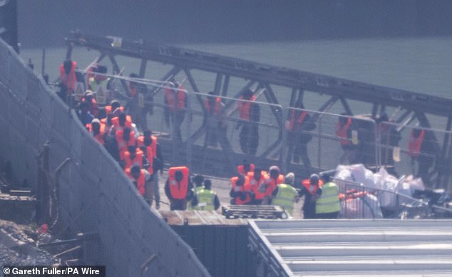 People thought to be migrants being brought into Dover after making a small boat crossing last week