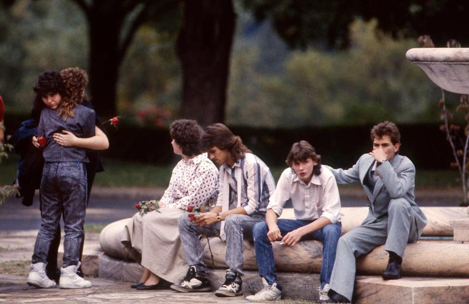 Friends and classmates of Chad and Jason Burnett comforted each other after the brothers were buried with their mother, Judith Robirds Smith, at the Woodlawn Memorial Park Cemetery Oct. 6, 1989.