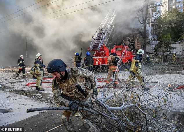 Firefighters at a residential building destroyed by a Shahed 136 drone attack in Kiev, Ukraine, in 2022