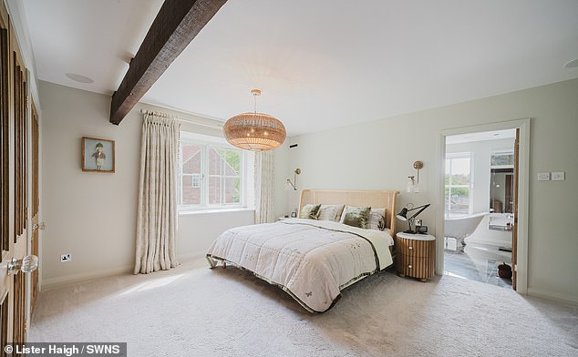 The master bedroom has an en-suite bathroom with a detached roll-top bath, and a dressing room