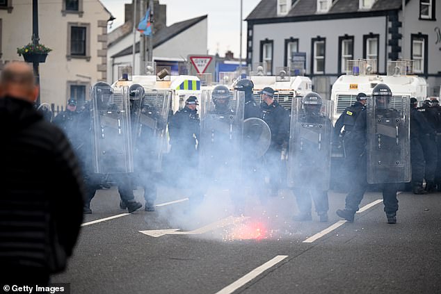 PSNI riot squad officers form a blockade on Harryville bridge in Ballymena last night to stop potential rioters from accessing the Clonavon terrace area