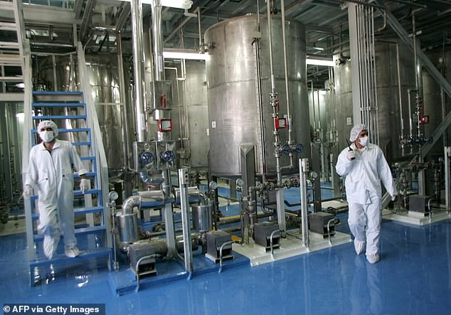 Israeli hit more than 400 targets in the past 24 hours as part of Operation Rising Lion, including dozens of missile sites and air defence systems in Tehran (pictured: Iranian technicians work at the Isfahan Uranium Conversion Facilities)