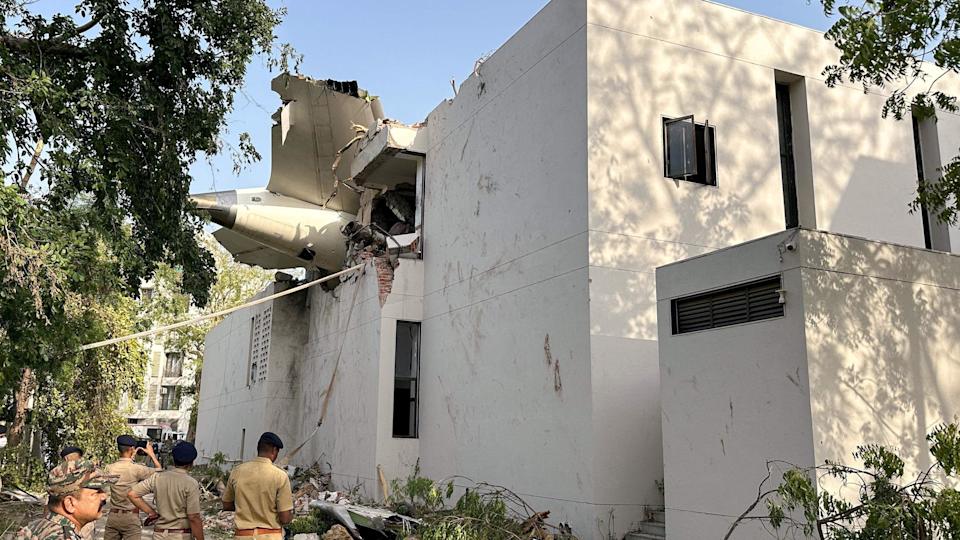 A tail of an Air India Boeing 787 Dreamliner plane that crashed is seen stuck on a building after the incident in Ahmedabad, India, June 12, 2025. REUTERS/Amit Dave