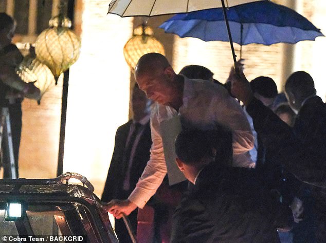 Bezos had on black slacks and his white dress shirt was slightly undone