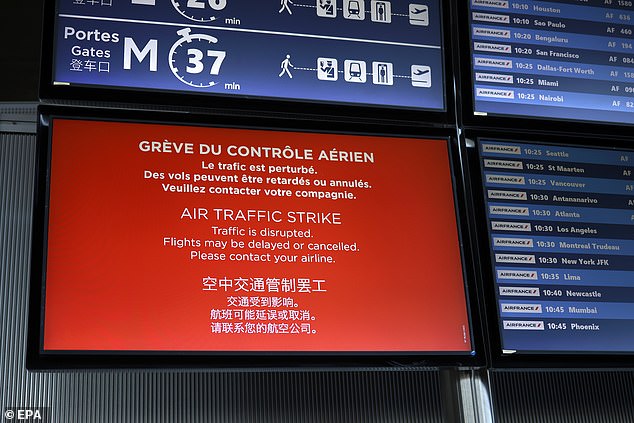 A flight information board inside Roissy-Charles de Gaulle Airport in Paris today