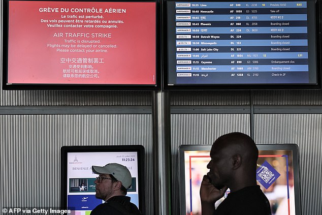A flight information board inside Roissy-Charles de Gaulle Airport in Paris today