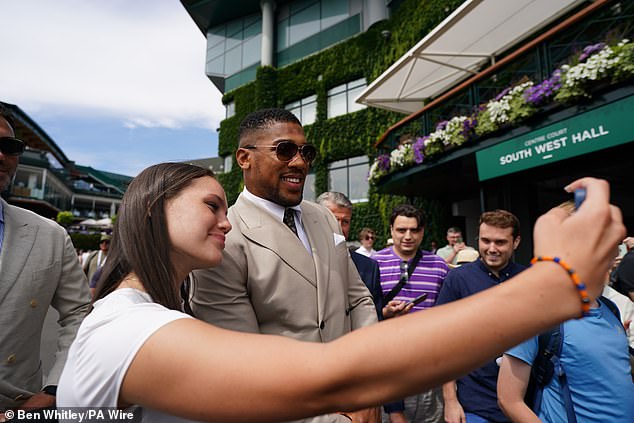 Fans went wild the boxer as they battled to get a snap