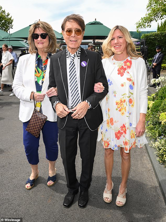 Wimbledon icon Sir Cliff Richard was joined by two female pals to take his seat in the Royal box