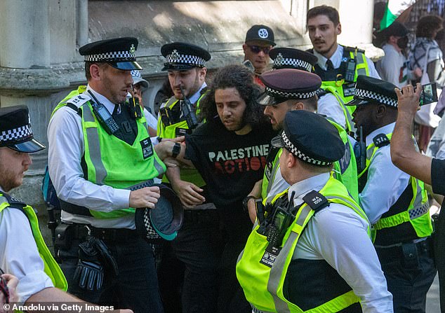 Police arrest a Palestine Action activist during a solidarity protest today