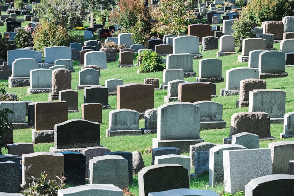 A cemetery with numerous gravestones.