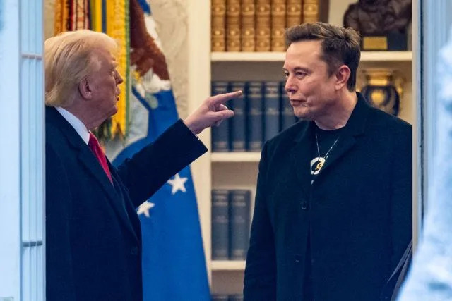 ROBERTO SCHMIDT/AFP via Getty Donald Trump gestures toward Elon Musk in the Oval Office on March 14, 2025
