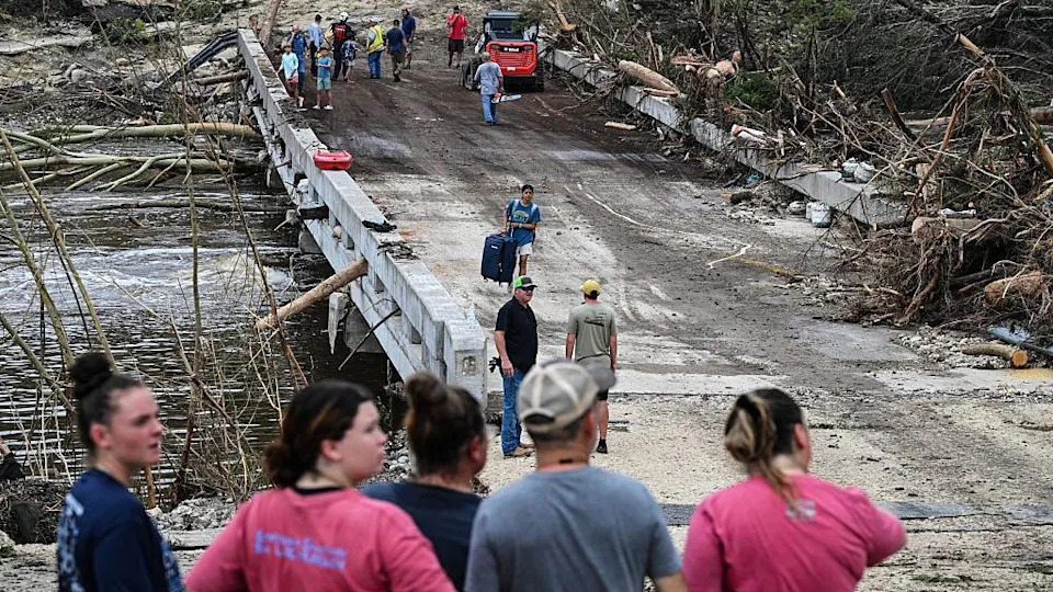 People look at muddied bridge