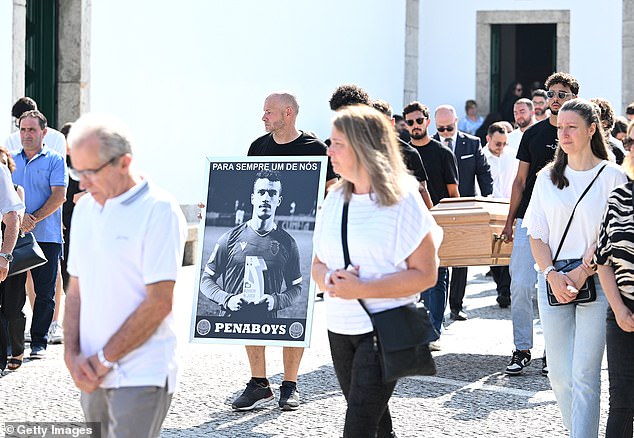 A poster of Andre Silva was carried as the coffins are walked to the Church ahead of the funeral for him and his brother Diogo Jota