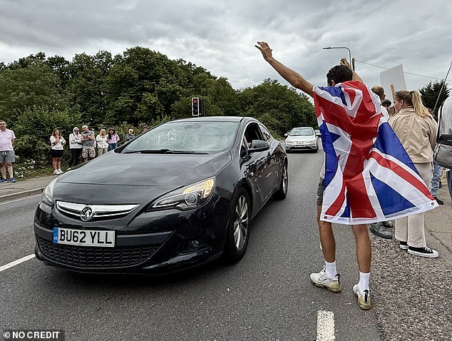 Beyond Union Jacks - others held a flag of St George with the slogan written in black: ¿Save Our Kids¿