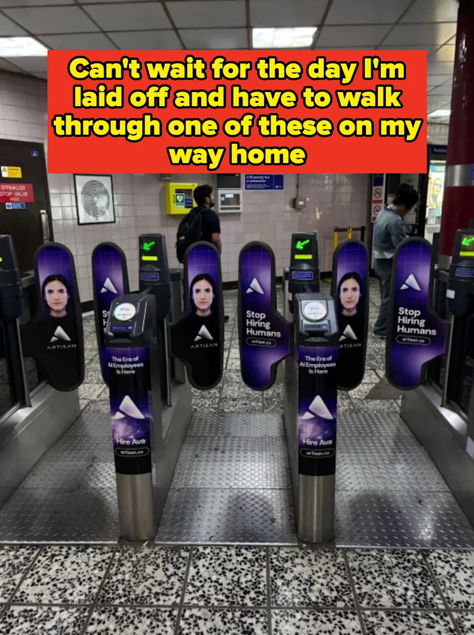 Subway turnstiles display ads featuring a person’s face and the text: "Stop hiring humans" and "Hire Ava," promoting a digital assistant service. Caption: "Can't wait for the day I'm laid off and have to walk through one of these on my way home"