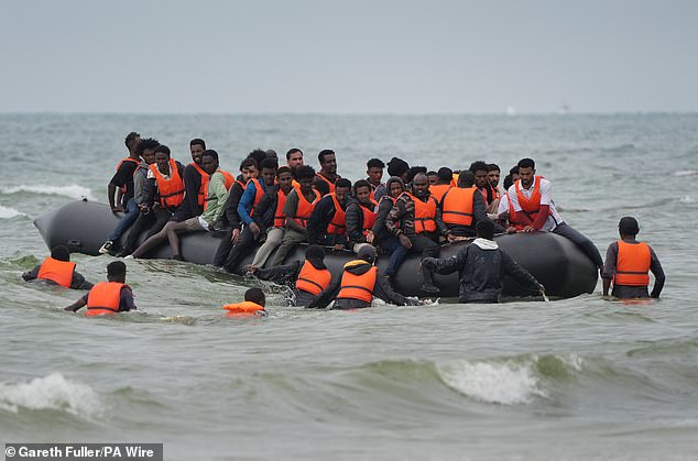 According to the latest government figures at least 21,000 people have embarked on the perilous journey across the Channel since January. Pictured: Migrants scramble to board a small boat near Wimereux in France on Thursday