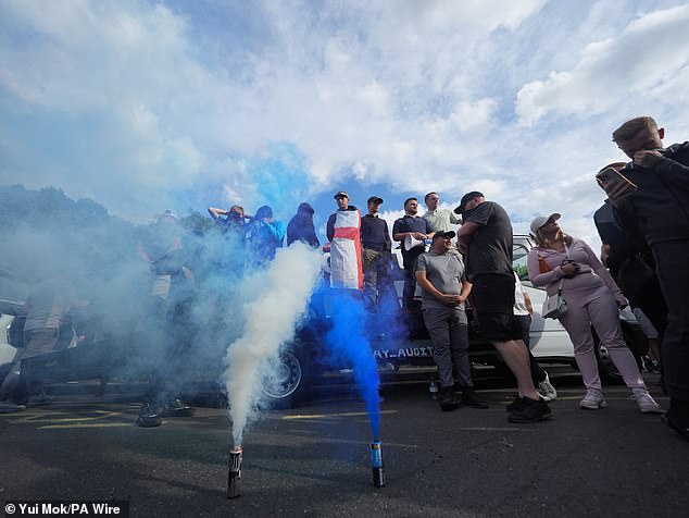Blue and white smoke bombs were let off outside the hotel in Epping as hundreds of protestors gathered
