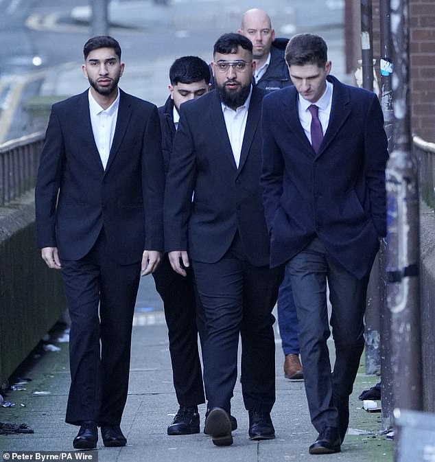 Mohammed Fahir Amaaz (left) and Muhammed Amaad (centre) arrive at Liverpool Magistrates' Court on January 16 for their first hearing after the fracas at Manchester Airport Terminal 2