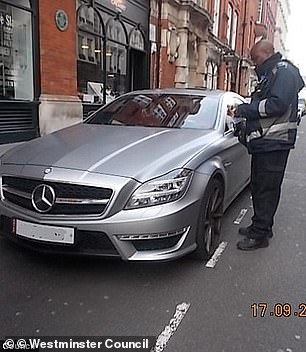Parking enforcement officers from Westminster Council are seen issuing fines after two luxury cars were parked illegally