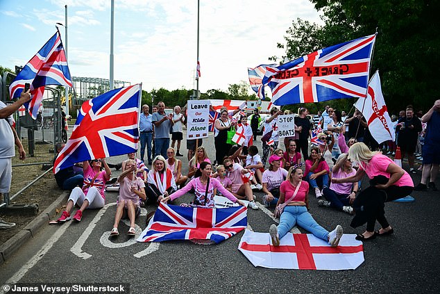 Anti migrant protesters demonstrate in the road at the Marriott Hotel in Cheshunt where asylum seekers are staying