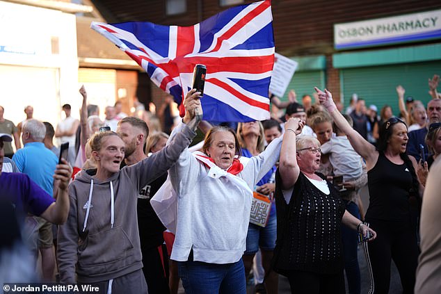 Anti-migrant protesters face off with anti-racism campaigners near the TLK Apartments and Hotel in Orpington
