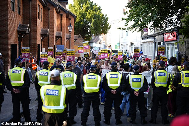 People take part in the Stand Up To Racism rally near the TLK Apartments and Hotel in Orpington