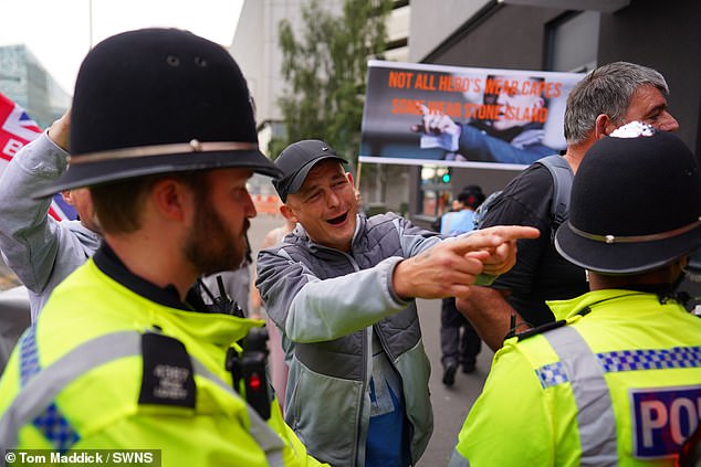 A group of pro-migrant campaigners face off with a small group of anti-migrant campaigners outside Highcross House Apart Hotel in Leicester