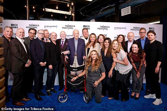 Adler — seen standing in the center with his surviving Sopranos costars and colleagues in June 2024 in NYC — revealed in his memoir that year that he appeared in the Sopranos pilot against his doctor's orders