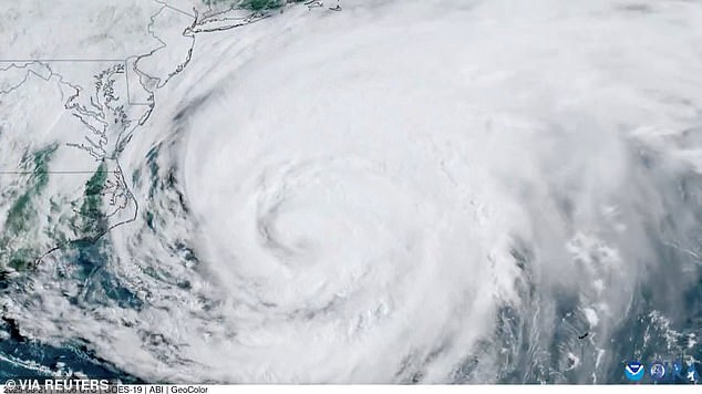 Now, the Met Office has warned that remnants of Hurricane Erin are set to bring 'very large waves' to the UK, with those visiting the coast warned of an increased danger. Pictured: a satellite image shows Hurricane Erin circling over the Atlantic Ocean on August 21