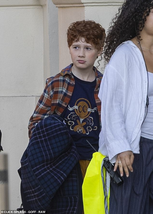Alistair wore a plaid over shirt which was teamed with corduroy trousers along with a thick duffel coat and school bag for scenes