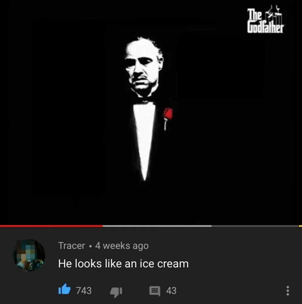 A comment on an image of a stern-looking man in a suit with a red flower, reading: "He looks like an ice cream."