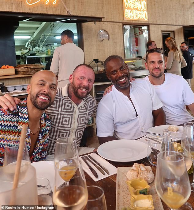 Rochelle Humes also raised eyebrows after sharing a photo of Myleene Klass's ex-husband Graham (centre left) posing with her husband Marvin (left) in Ibiza