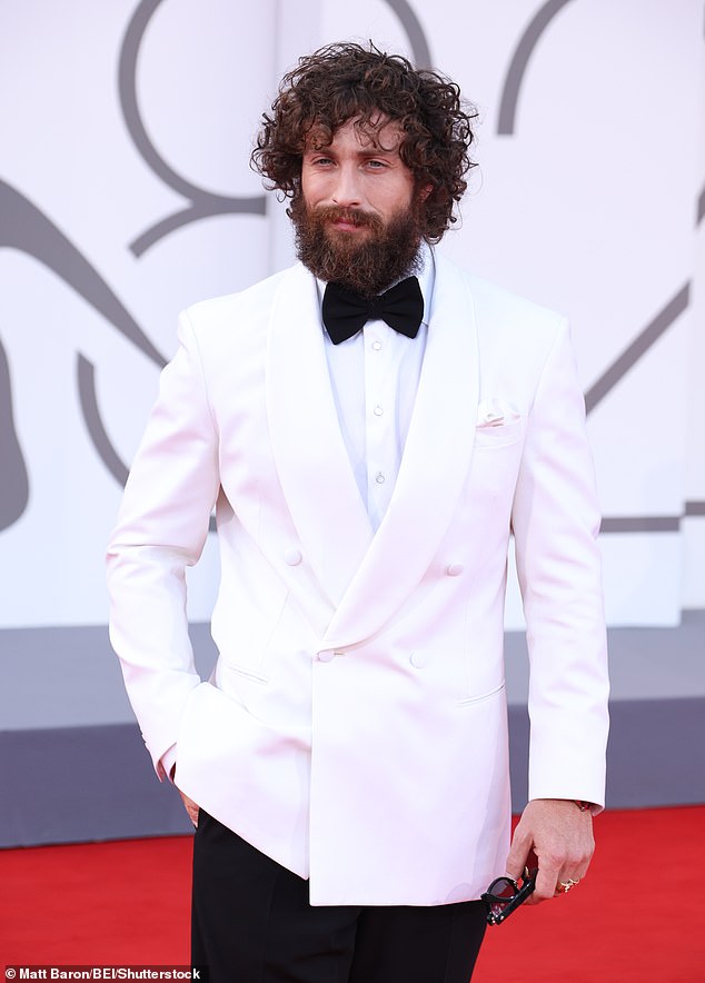 Slipping his feet into shiny dress shoes the actor also wore a huge wristwatch, after signing a deal with official 007 watch provider Omega