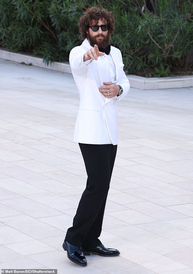 Aaron cut a suave figure in a white tailored blazer and smart black trousers, which were teamed with a crisp shirt and bow tie