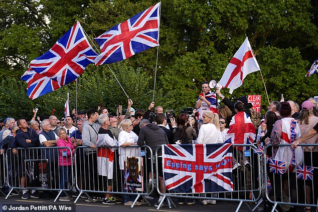 More protesters wave Union Jacks and English flags, with one reading: 'Epping says no'