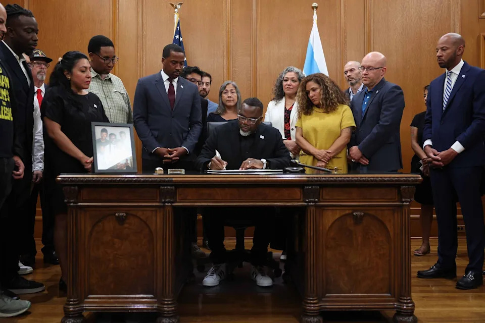 Chicago Tribune/TNS - Mayor Brandon Johnson signs an executive order titled "Protecting Chicago," in response to the possible local deployment of federal military and other personnel in the coming days, at City Hall, on Saturday, Aug. 30, 2025, in Chicago.