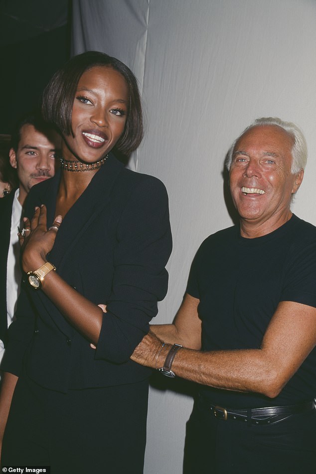 Armani smiles as he attends a private party with model Naomi Campbell in 1996