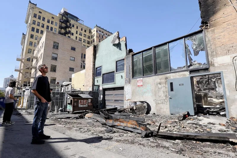 Christian Priskos, co-owner of Whiskey Street and White Horse, looks at the scene of a structure fire that destroyed four businesses on the 300 South block of Main Street in downtown Salt Lake City on Aug. 12. Whiskey Street, White Horse, London Belle and Los Tapatios were all destroyed in the fire. | Kristin Murphy, Deseret News