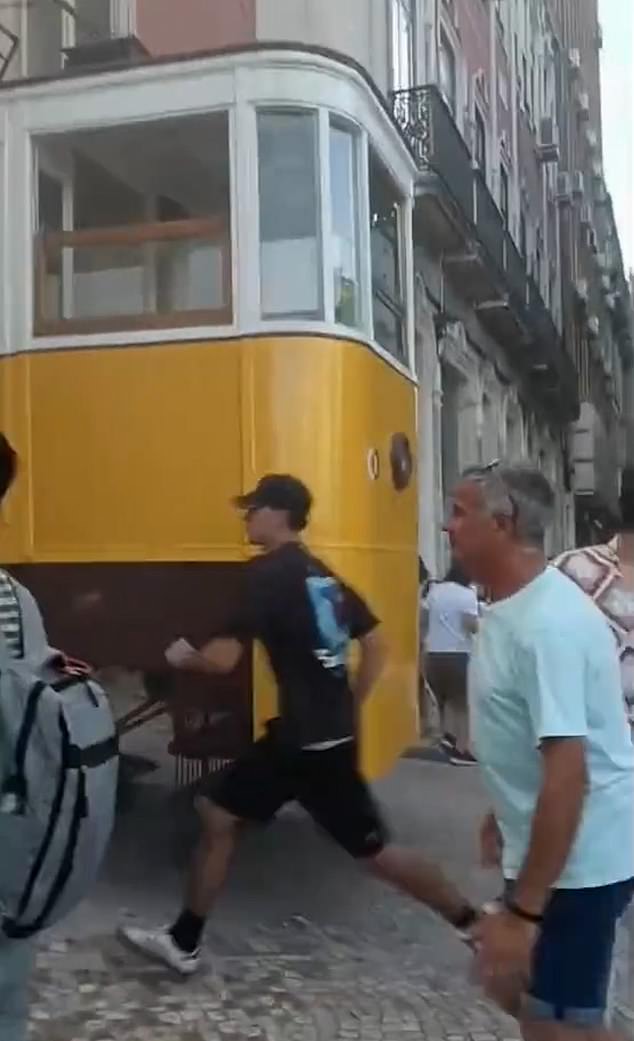 In the panic, one witness can be heard shouting, 'There are kids under the tram' as the screams of children thought to be trapped beneath the rubble ring out
