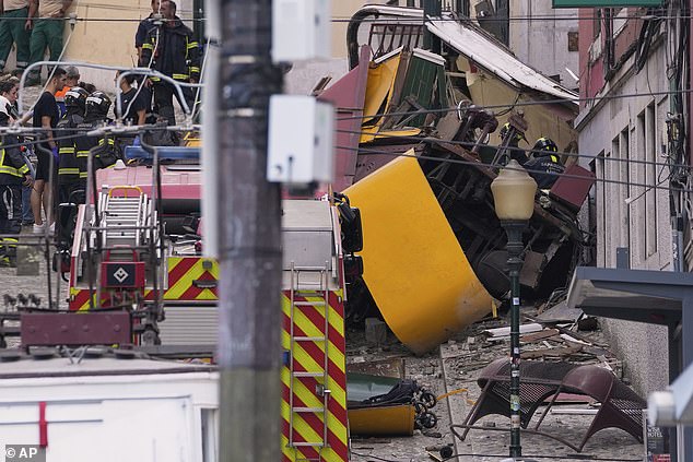 Emergency teams work at the site of a derailed electric streetcar in Lisbon, Portugal