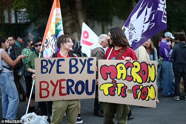 Protesters hold placards which read 'Bye Bye Bayrou' as they gather for a 'Bayrou's farewell party' protest in front of the city hall in Nantes