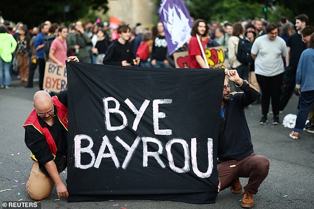 Protesters hold a banner which reads 'Bye Bayrou' as they gather for a 'Bayrou's farewell party'