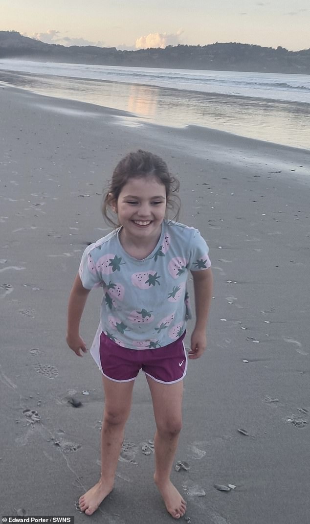 Willow is pictured barefoot on a sandy beach in New Zealand after the family upped sticks and left